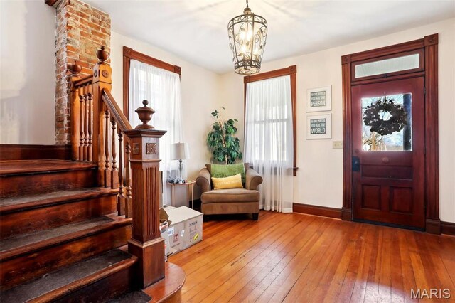 502 W 5th St, Washington, MO 63090 - foyer featuring wood-type flooring, a chandelier, and stairs