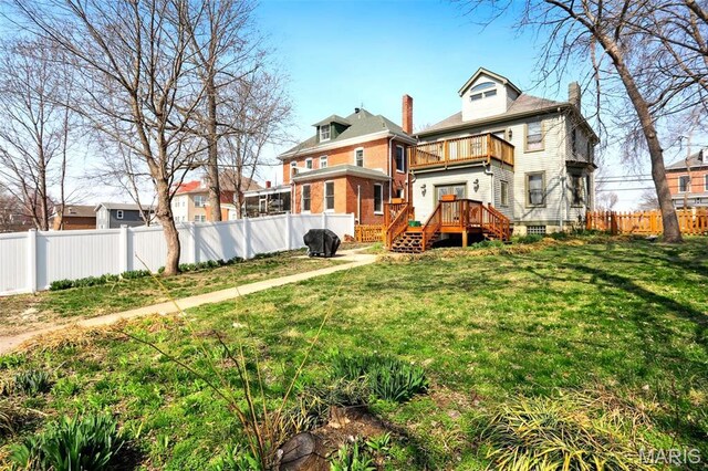 502 W 5th St, Washington, MO 63090 - back of house with a balcony, a fenced backyard, a chimney, brick siding, and a wooden deck