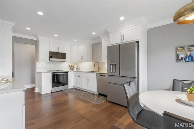 208 Ambridge Ct Unit 302, Chesterfield, MO 63017 - kitchen featuring stainless steel appliances, light countertops, white cabinetry, crown molding, and tasteful backsplash