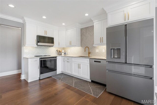 208 Ambridge Ct Unit 302, Chesterfield, MO 63017 - kitchen with appliances with stainless steel finishes, light countertops, white cabinetry, tasteful backsplash, and crown molding