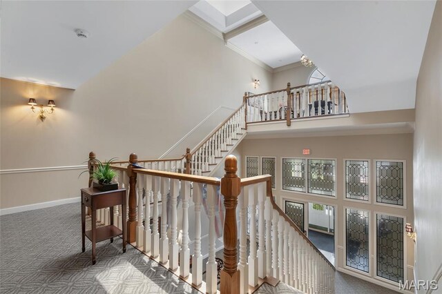 208 Ambridge Ct Unit 302, Chesterfield, MO 63017 - staircase featuring a high ceiling, carpet, and ornamental molding