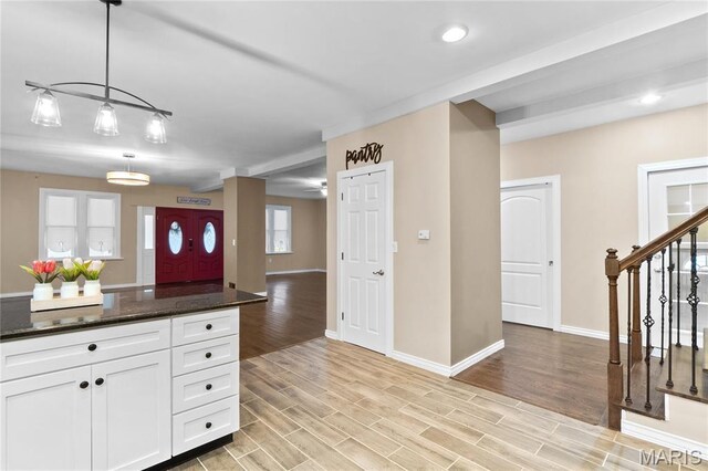 19 N 31st St N, Belleville, IL 62226 - kitchen with white cabinetry, light wood-style floors, hanging light fixtures, open floor plan, and dark stone counters