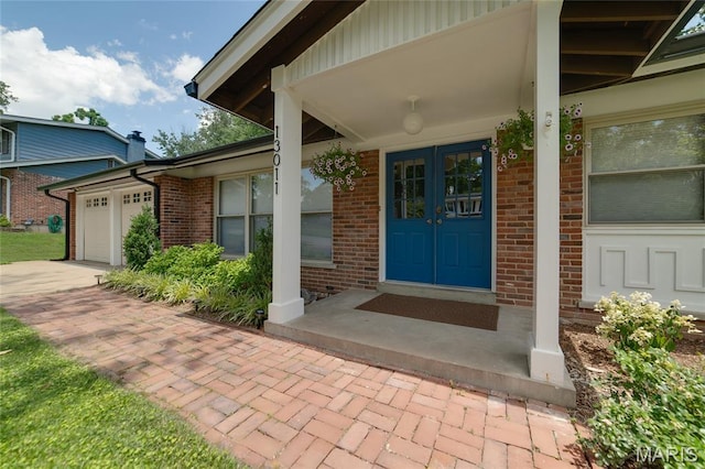 13011 Ambois Dr, Saint Louis, MO 63141 - property entrance featuring brick siding, an attached garage, and driveway