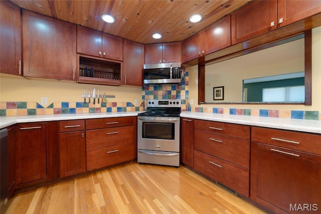 13011 Ambois Dr, Saint Louis, MO 63141 - kitchen featuring stainless steel appliances, light wood-style flooring, light countertops, decorative backsplash, and recessed lighting