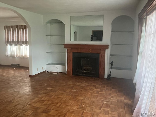 211 Edgar St, Gillespie, IL 62033 - unfurnished living room with a fireplace, plenty of natural light, and built in shelves
