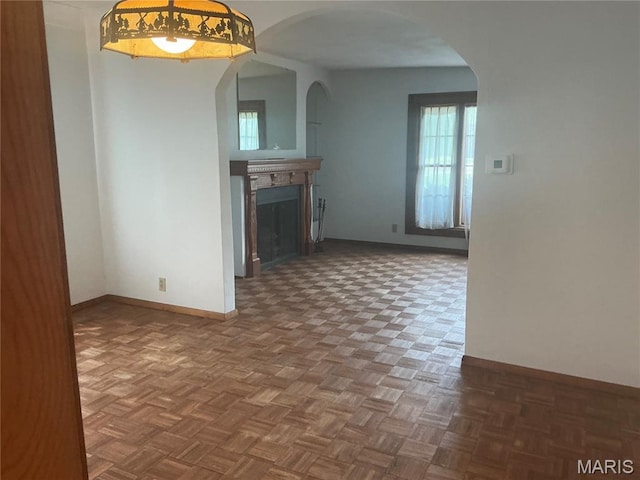 211 Edgar St, Gillespie, IL 62033 - unfurnished living room featuring a fireplace and arched walkways