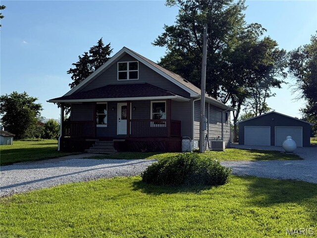 6596 County Road 263, Hannibal, MO 63401 - view of front of home featuring a garage, an outdoor structure, a front lawn, and covered porch