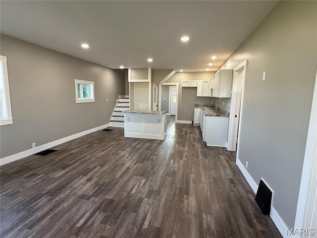 6596 County Road 263, Hannibal, MO 63401 - unfurnished living room with dark wood-style floors, recessed lighting, and stairway