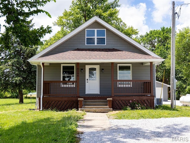 6596 County Road 263, Hannibal, MO 63401 - bungalow with covered porch, roof with shingles, and a front yard