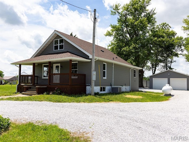 6596 County Road 263, Hannibal, MO 63401 - view of front of property featuring a garage, an outbuilding, covered porch, and roof with shingles