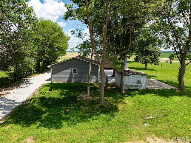6596 County Road 263, Hannibal, MO 63401 - view of side of property featuring a lawn and a shed
