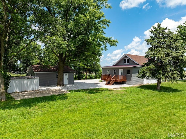 6596 County Road 263, Hannibal, MO 63401 - view of grassy yard with a wooden deck, an outdoor structure, and a patio area