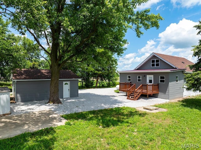 6596 County Road 263, Hannibal, MO 63401 - back of house with a deck, a lawn, and an outbuilding