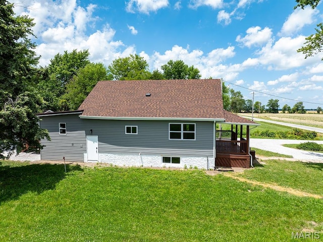 6596 County Road 263, Hannibal, MO 63401 - rear view of property featuring a lawn and roof with shingles
