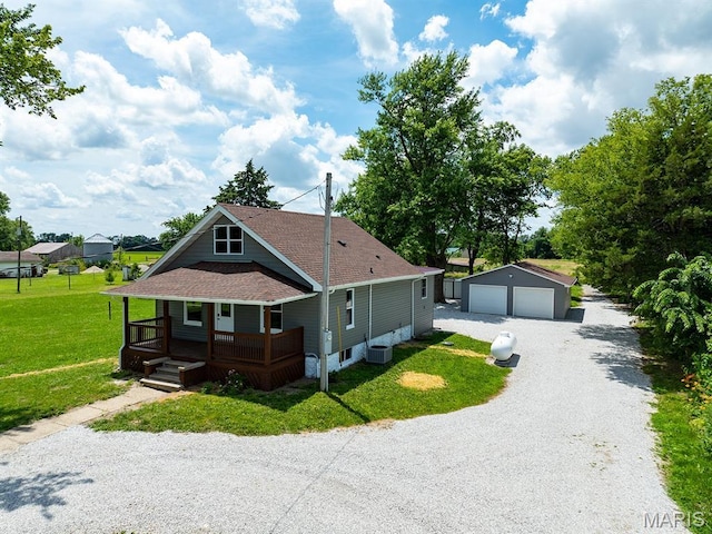 6596 County Road 263, Hannibal, MO 63401 - view of front of property with covered porch, an outdoor structure, a detached garage, a shingled roof, and a front lawn