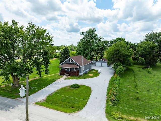 6596 County Road 263, Hannibal, MO 63401 - view of front facade with a detached garage, a front lawn, an outdoor structure, and covered porch