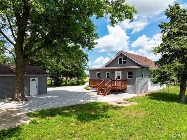 6596 County Road 263, Hannibal, MO 63401 - back of house featuring a deck, a lawn, and an outdoor structure