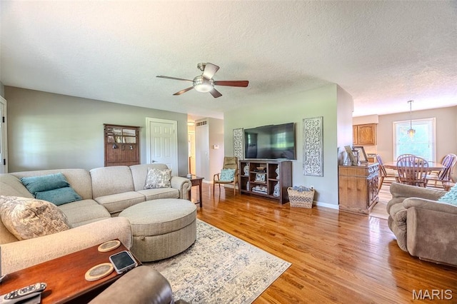 16930 Grace Rd, Lebanon, MO 65536 - living area with ceiling fan, light wood-type flooring, and a textured ceiling