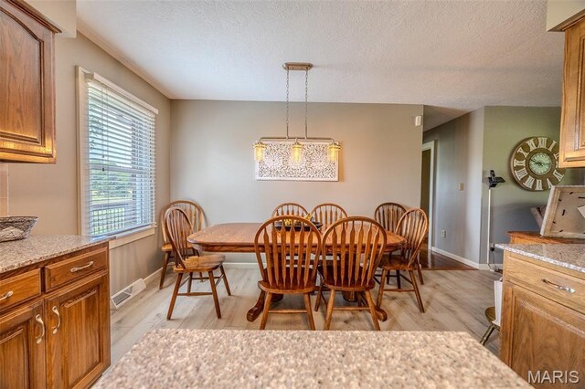 16930 Grace Rd, Lebanon, MO 65536 - dining room featuring light wood finished floors and a textured ceiling