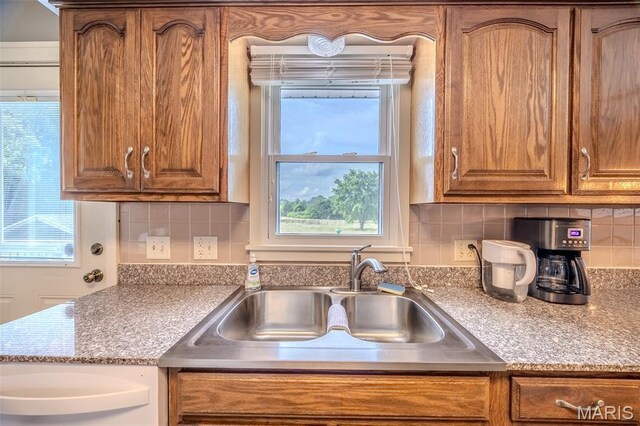 16930 Grace Rd, Lebanon, MO 65536 - kitchen featuring brown cabinetry and backsplash