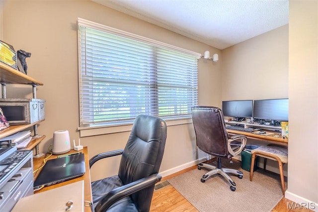16930 Grace Rd, Lebanon, MO 65536 - home office featuring wood finished floors and a textured ceiling