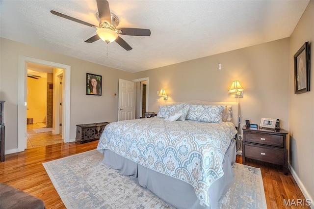 16930 Grace Rd, Lebanon, MO 65536 - bedroom featuring wood finished floors, a textured ceiling, and a ceiling fan