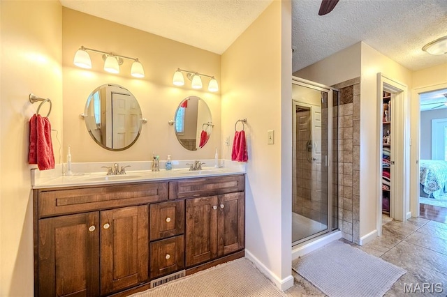 16930 Grace Rd, Lebanon, MO 65536 - bathroom featuring double vanity, a shower stall, a textured ceiling, tile patterned flooring, and a walk in closet