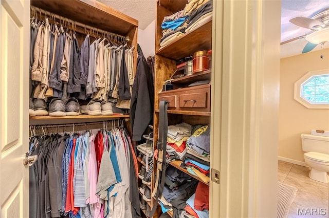 16930 Grace Rd, Lebanon, MO 65536 - walk in closet featuring tile patterned flooring and a ceiling fan