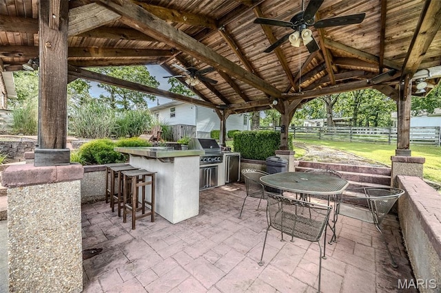 16930 Grace Rd, Lebanon, MO 65536 - view of patio featuring an outdoor kitchen, a gazebo, a ceiling fan, and a bar
