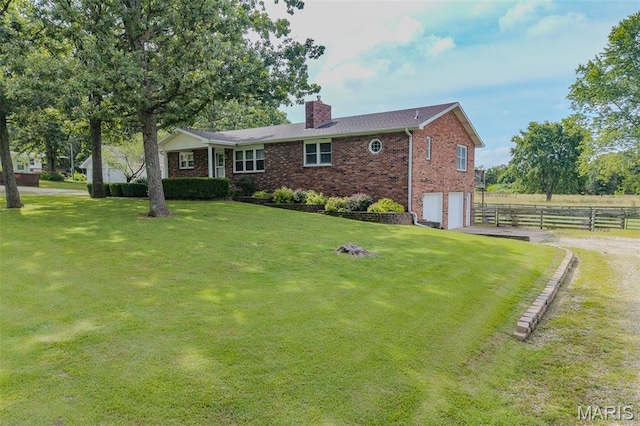 16930 Grace Rd, Lebanon, MO 65536 - single story home with driveway, brick siding, a chimney, and an attached garage