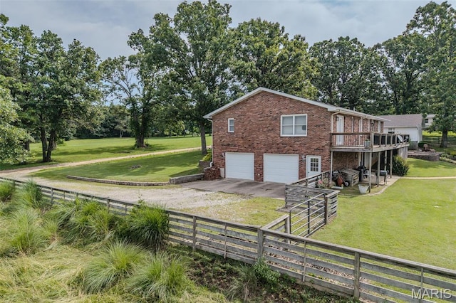 16930 Grace Rd, Lebanon, MO 65536 - view of side of home featuring driveway, a garage, brick siding, a deck, and view of scattered trees