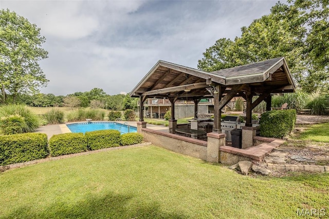 16930 Grace Rd, Lebanon, MO 65536 - outdoor pool featuring a gazebo, a lawn, a diving board, and an outdoor kitchen