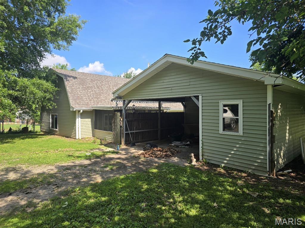828 S Lewis St, Dexter, MO 63841 - back of property with a lawn, roof with shingles, and a carport