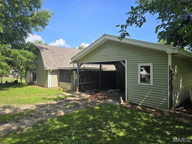 828 S Lewis St, Dexter, MO 63841 - back of property with a lawn, roof with shingles, and a carport