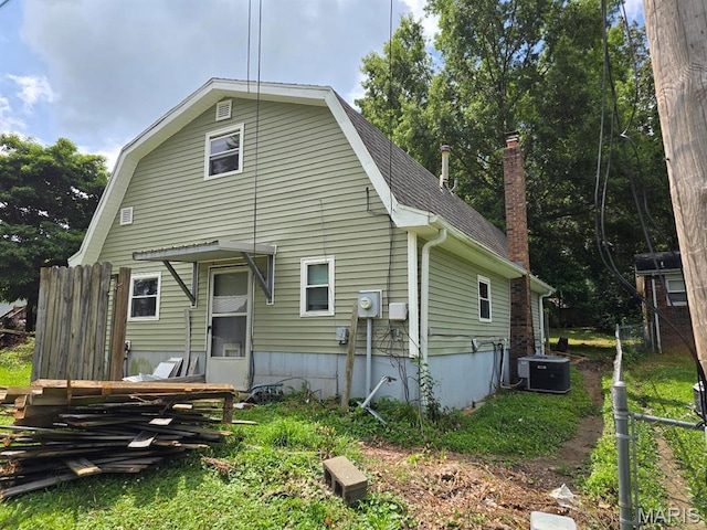 828 S Lewis St, Dexter, MO 63841 - rear view of property with a gambrel roof, roof with shingles, and a chimney