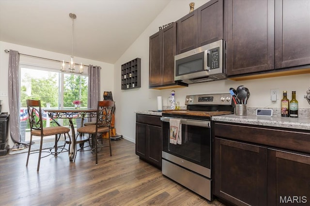 8280 Obrien Dr, Cedar Hill, MO 63016 - kitchen with stainless steel appliances, vaulted ceiling, dark wood-style flooring, dark brown cabinets, and decorative light fixtures