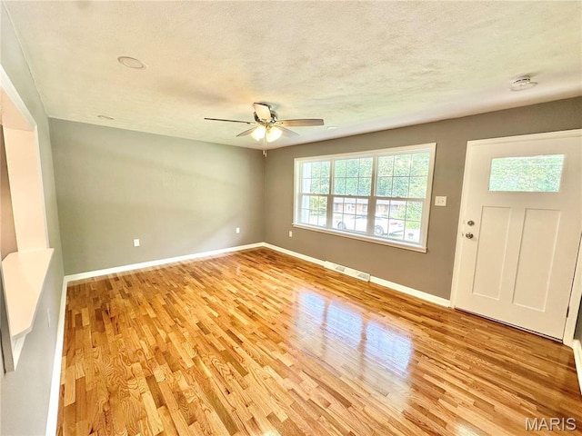 4 Fairview Dr, Saint Charles, MO 63303 - spare room featuring light wood-style floors, ceiling fan, a textured ceiling, and a smoke detector