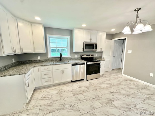 4 Fairview Dr, Saint Charles, MO 63303 - kitchen featuring appliances with stainless steel finishes, white cabinets, a chandelier, stone counters, and light marble finish floors