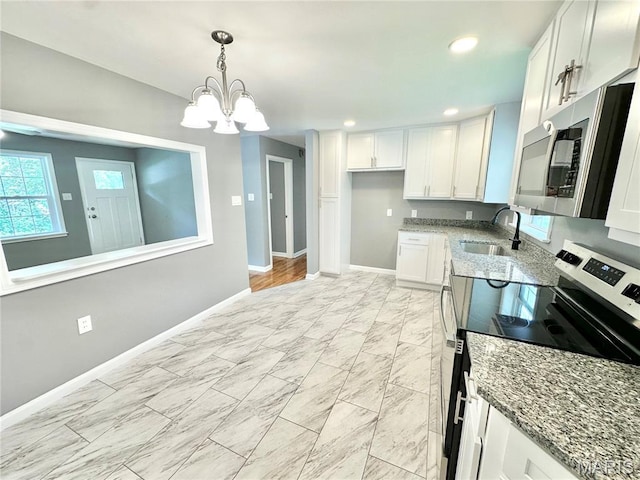 4 Fairview Dr, Saint Charles, MO 63303 - kitchen with appliances with stainless steel finishes, stone countertops, a chandelier, light marble finish floors, and white cabinets