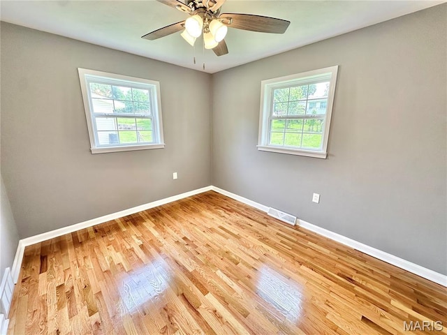 4 Fairview Dr, Saint Charles, MO 63303 - unfurnished room featuring healthy amount of natural light, wood finished floors, and ceiling fan