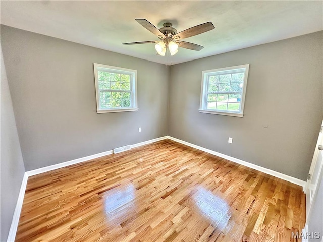4 Fairview Dr, Saint Charles, MO 63303 - unfurnished room featuring plenty of natural light, light wood-style floors, and a ceiling fan