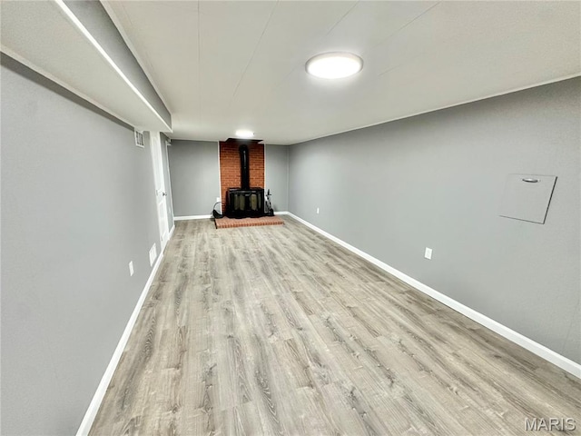 4 Fairview Dr, Saint Charles, MO 63303 - unfurnished living room with a wood stove and wood finished floors