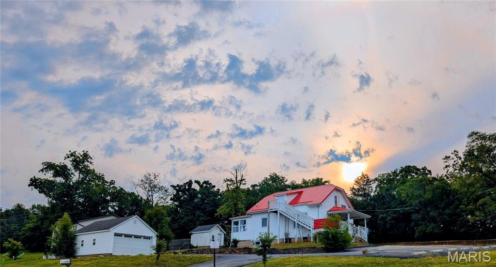 8528 Red Rose Ct, Cedar Hill, MO 63016 - view of front facade with an outbuilding, a garage, and view of scattered trees