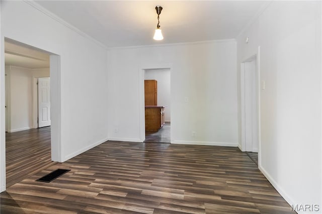 1009 S 3rd St, De Soto, MO 63020 - spare room featuring dark wood-type flooring and crown molding