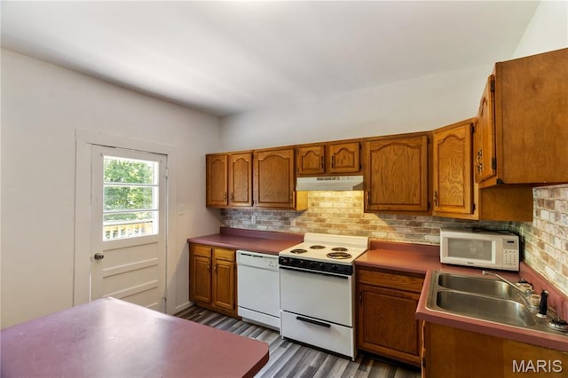1009 S 3rd St, De Soto, MO 63020 - kitchen with white appliances, under cabinet range hood, dark wood-type flooring, and brown cabinetry