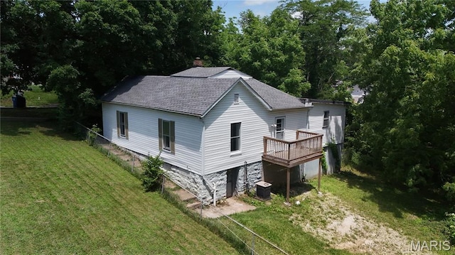 1009 S 3rd St, De Soto, MO 63020 - rear view of house with roof with shingles, a yard, a wooden deck, and a chimney