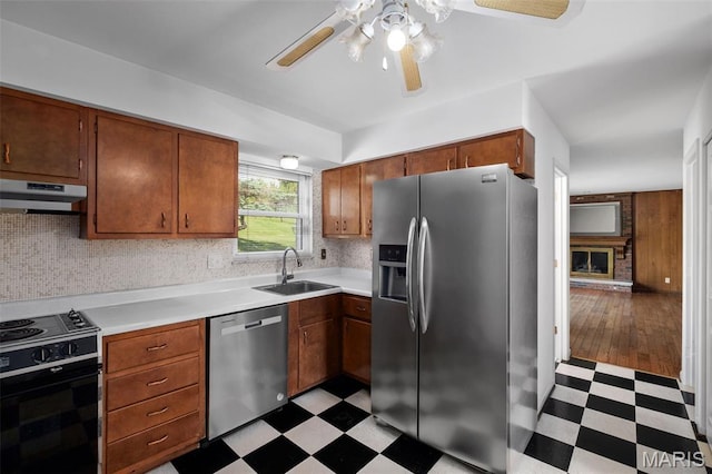 7849 Cassia Ct, Saint Louis, MO 63123 - kitchen with appliances with stainless steel finishes, light floors, under cabinet range hood, a ceiling fan, and light countertops