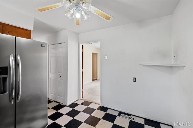 7849 Cassia Ct, Saint Louis, MO 63123 - kitchen featuring stainless steel fridge, tile patterned floors, ceiling fan, and brown cabinetry