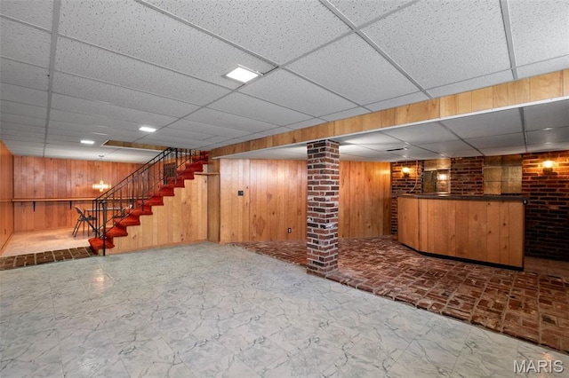 7849 Cassia Ct, Saint Louis, MO 63123 - finished basement featuring a paneled ceiling, wooden walls, bar area, and stairs