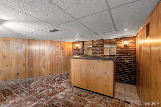 7849 Cassia Ct, Saint Louis, MO 63123 - indoor bar featuring a paneled ceiling, wood walls, and brick flooring